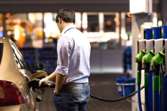 Youngmanfuelinghiscaratthegasstation petrol station lighting